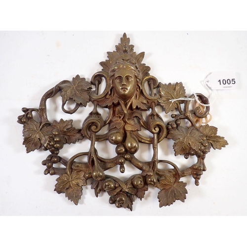 1005 - A 19th century cast brass pierced mask and vine plaque, 22 x 25cm