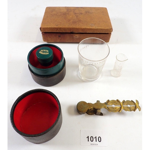 1010 - A vintage medicine measure in leather case, a leather travelling jewellery case and a sovereign scal... 