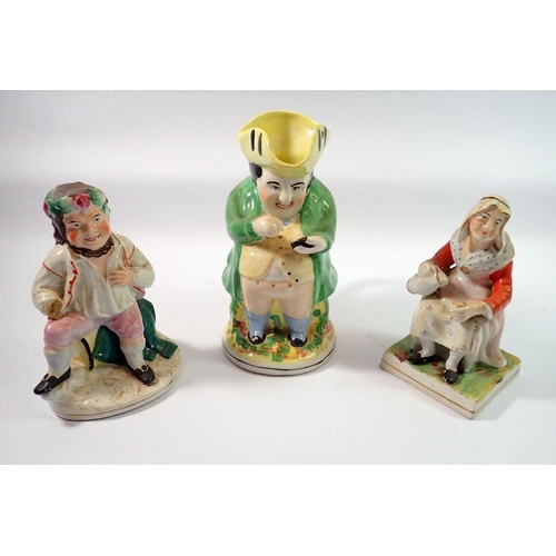 102 - A Staffordshire figure of an old woman, a Bacchus figure, a/f and a Toby jug