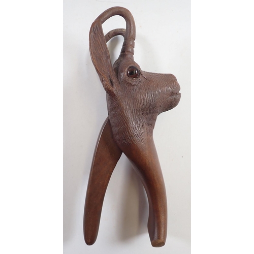 1041 - A Black Forrest novelty carved wood deer nut craker with glass eyes, 21cm