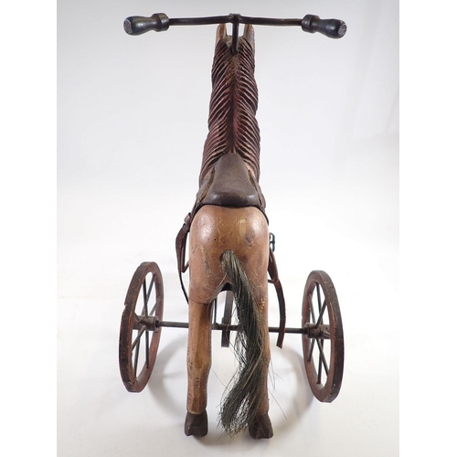 1043 - A miniature vintage velocipede horse, 37cm tall