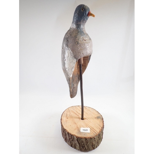 1045 - An unusual mounted mid 20th century 'perching' decoy pigeon, 52cm tall