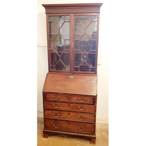 1050 - A Georgian mahogany bureau bookcase of small proportions with astragal glazed doors over slope front... 