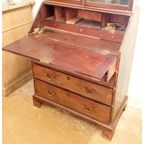 1050 - A Georgian mahogany bureau bookcase of small proportions with astragal glazed doors over slope front... 