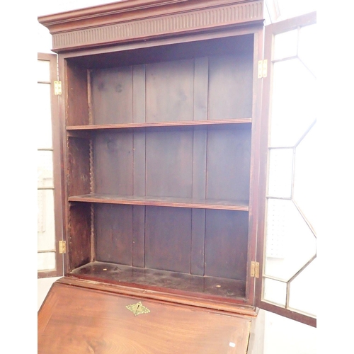 1050 - A Georgian mahogany bureau bookcase of small proportions with astragal glazed doors over slope front... 