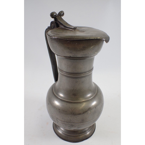 1057 - A large 18th century pewter flagon dated 1758 with touchmarks, 30cm tall