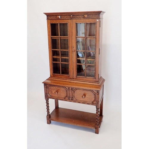 1066 - An early 20th century bookcase of very small proportions with two glazed doors over drawer all raise... 