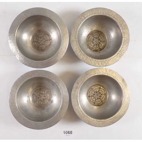 1068 - A set of four unusual Tudric pewter small dishes with Tudor Rose to base, made for Liberty, No 01122... 