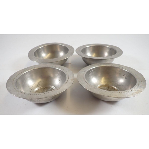 1068 - A set of four unusual Tudric pewter small dishes with Tudor Rose to base, made for Liberty, No 01122... 