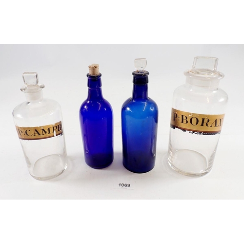 1069 - Two labelled glass chemists jars and two Bristol blue apothecary bottles, tallest 21cm