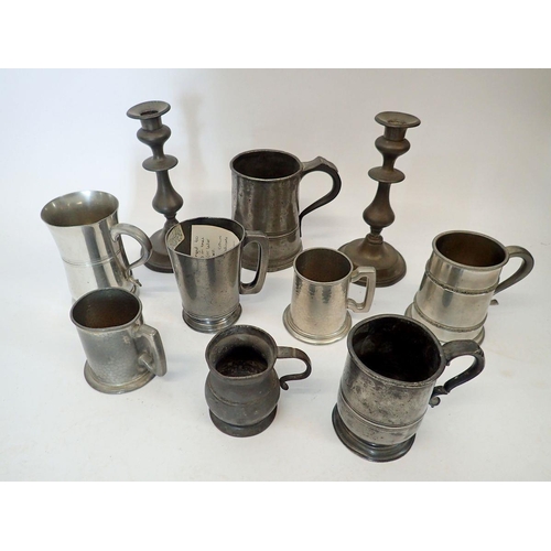 1071 - A collection of pewter tankards and a pair of candlesticks