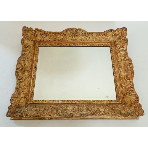 1074 - A 19th century heavy carved oak and gesso framed mirror with shell and foliage decoration, 48 x 56cm