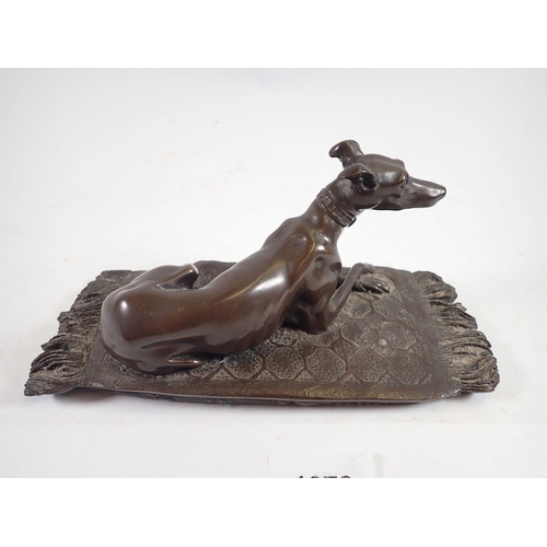 1078 - A bronze finish group recumbent whippet on rug, 19cm wide 'OFA' monogram