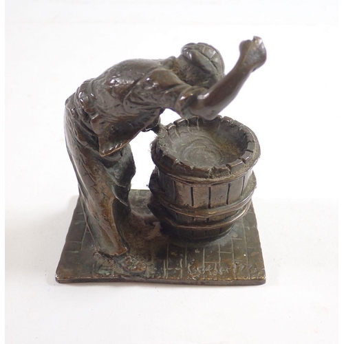 1081 - A small bronze figure of a barrel Cooper at work, 10cm tall signed Butler 77