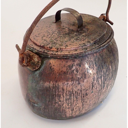 1090 - A Victorian large oval cooking pot with lid and hinged iron handle, 47cm wide