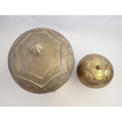 1092 - Two Nigerian 'Bida' brass embossed circular food boxes, largest 30cm tall