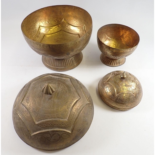 1092 - Two Nigerian 'Bida' brass embossed circular food boxes, largest 30cm tall