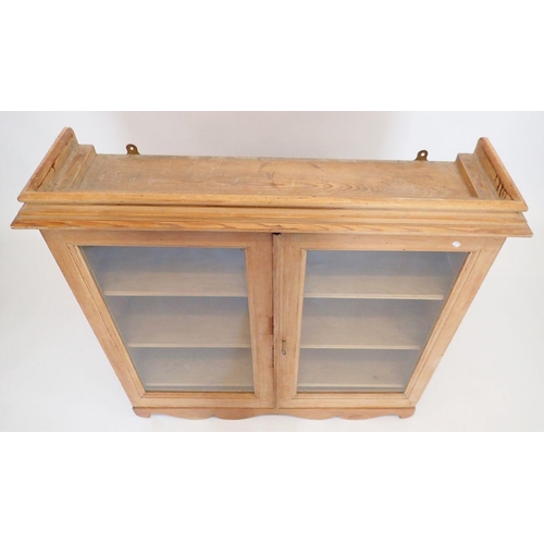 1127 - A 19th century pine glazed wall bookcase with three shelves and three small drawers within, 92 x 92 ... 