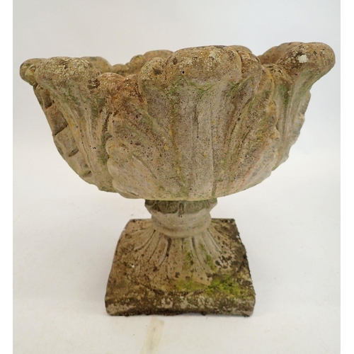 1132 - A reconstituted stone garden urn with foliage decoration 43cm tall