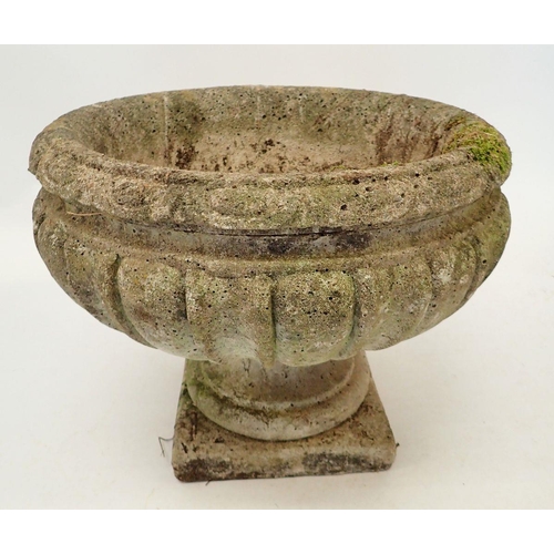 1134 - A reconstituted stone fluted urn 37cm tall