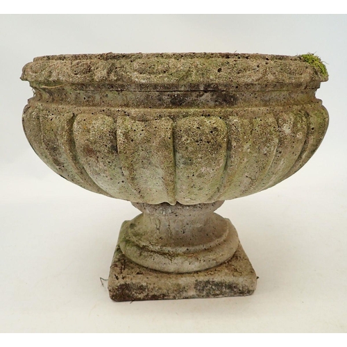 1134 - A reconstituted stone fluted urn 37cm tall