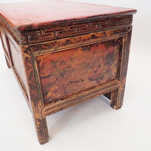 1140 - A small Chinese red painted wooden chest with floral decoration, secret door to reverse, 75 x 38 x 4... 