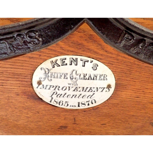 1144 - A Kents patent oak knife cleaner with makers plaque on a cast iron frame