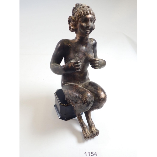 1154 - An antique bronze figure of a female faun seated (lacking base) 22cm tall