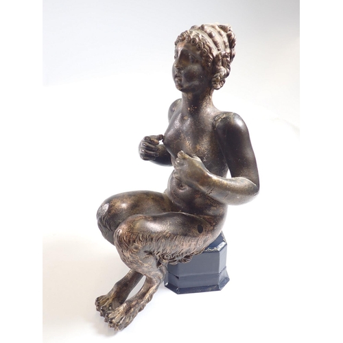 1154 - An antique bronze figure of a female faun seated (lacking base) 22cm tall