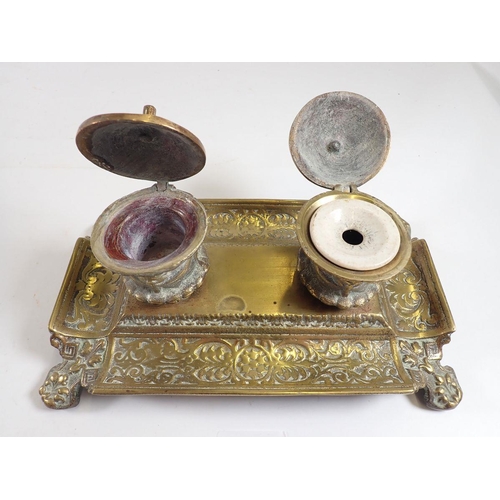 1157 - A cast brass inkstand with strapwork decoration, 24cm wide