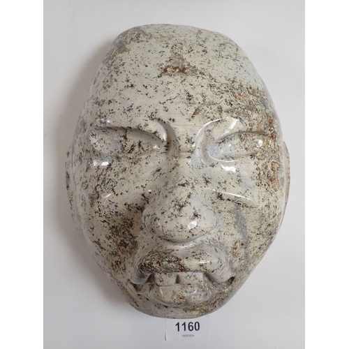 1160 - A pale stone carving of a face mask in Olmec style, 23 x 20cm