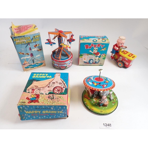 1248 - Three Japanese mechanical tin plate toys - 'Vacationland Airplane rRde' and 'Happy Grandpa with Ring... 