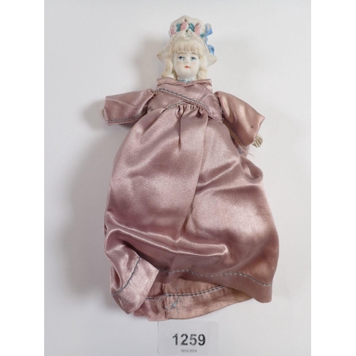 1259 - A Victorian 'bonnet head' doll with bisque head and hands and fabric body, 14cm