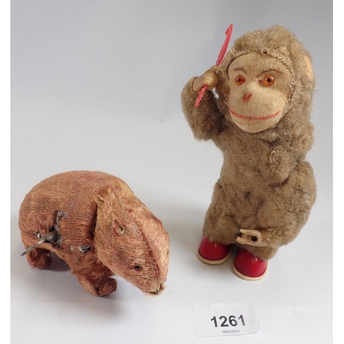 1261 - An early 20th century automaton toy monkey combing his hair and a clockwork bear - both reputed to b... 