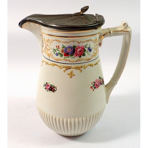 128 - A Winton floral painted jug with pewter lid, 18cm tall