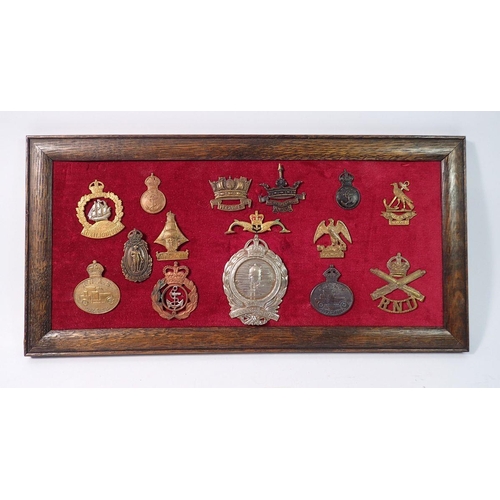 1333 - A framed display of fifteen Royal Navy cap badges including 'Strike Hawke', 'Steady Hood', 'Mine Cle... 