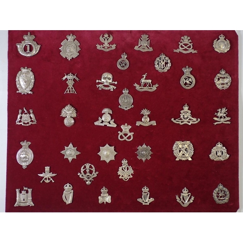 1335 - A framed and glazed display of thirty six  military cap badges, all marked 'Silver', sample taken al... 