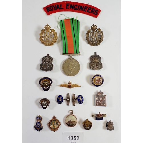 1352 - A box of military badges etc.