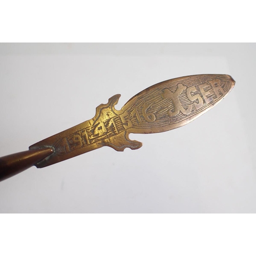 1355 - A copper Trench Art paperknife, a Royal Navy Copper measure with anchor mark to base and a glass bot... 