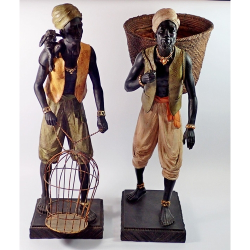 1379 - Two large African Indian decorative resin figures, man with monkey and cage and man with fruit baske... 