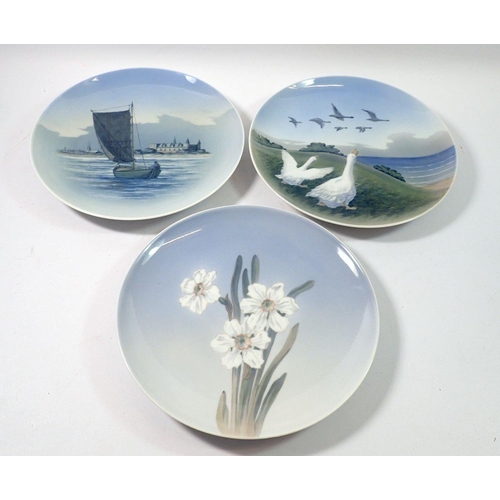 138 - Three Copenhagen plates painted geese, narcisus and sailing boat, 25.5cm diameter