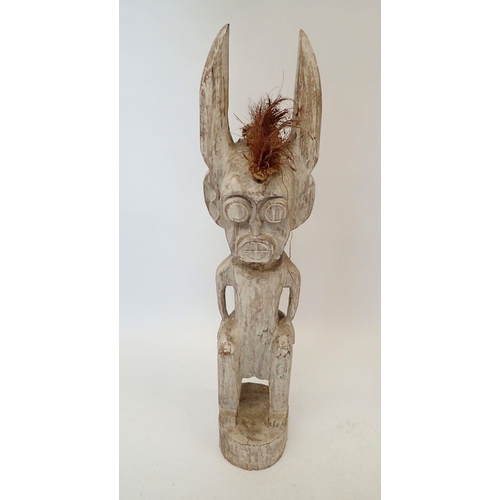 1390 - A large carved and painted Voodoo tribal figure with long ears, 99cm tall