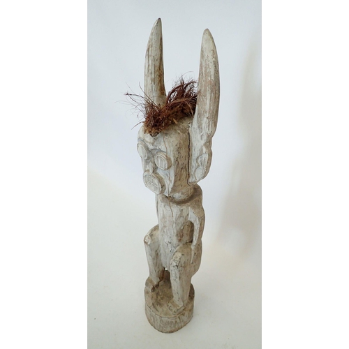 1390 - A large carved and painted Voodoo tribal figure with long ears, 99cm tall