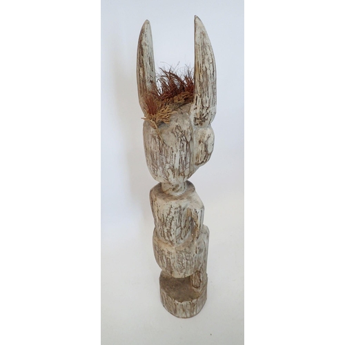 1390 - A large carved and painted Voodoo tribal figure with long ears, 99cm tall