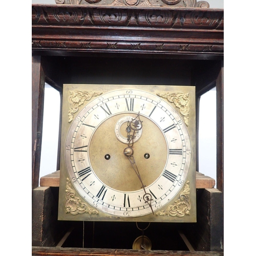 1391 - A 19th century continental oak cased longcase clock with square brass dial, the case ornately carved... 