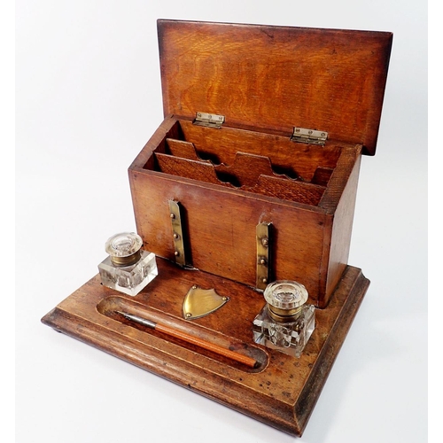 1395 - A Victorian oak correspondence box with rise top letter compartment and inkstand fitted two glass in... 