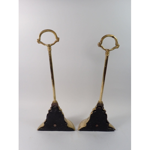 1399 - A pair of Georgian brass door stops or porters of bell form