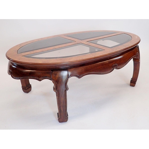 1402 - A Waring & Gillows oriental style oval coffee table with inset glass panels to top, 122 x 74 x 44cm