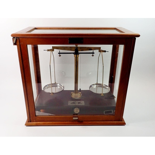 1420 - A Griffin & Tatlock set of balance scales in glazed case, 45cm wide