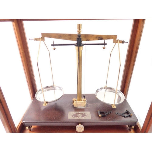 1420 - A Griffin & Tatlock set of balance scales in glazed case, 45cm wide